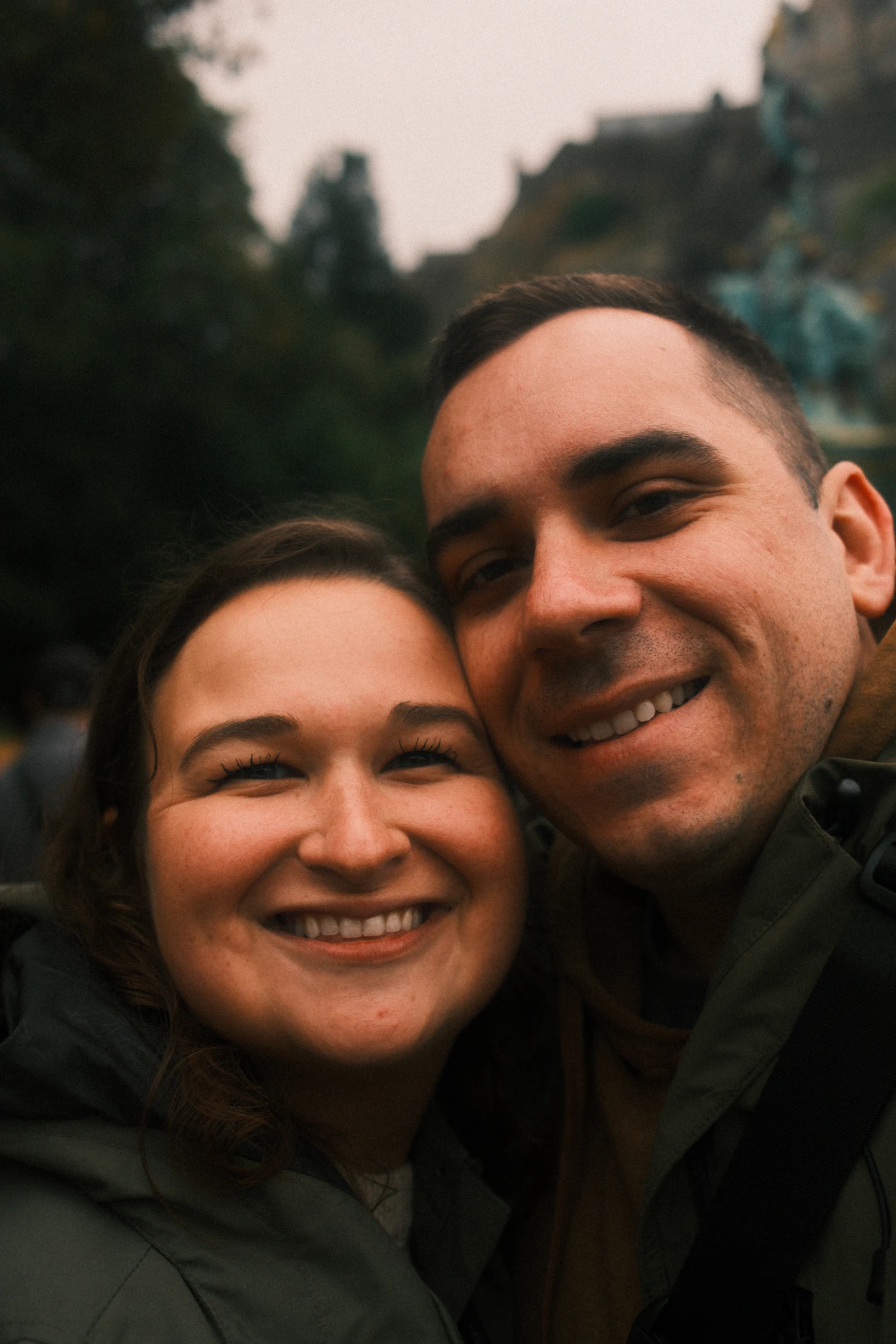 Lindsay and Brendan smiling together outdoors.